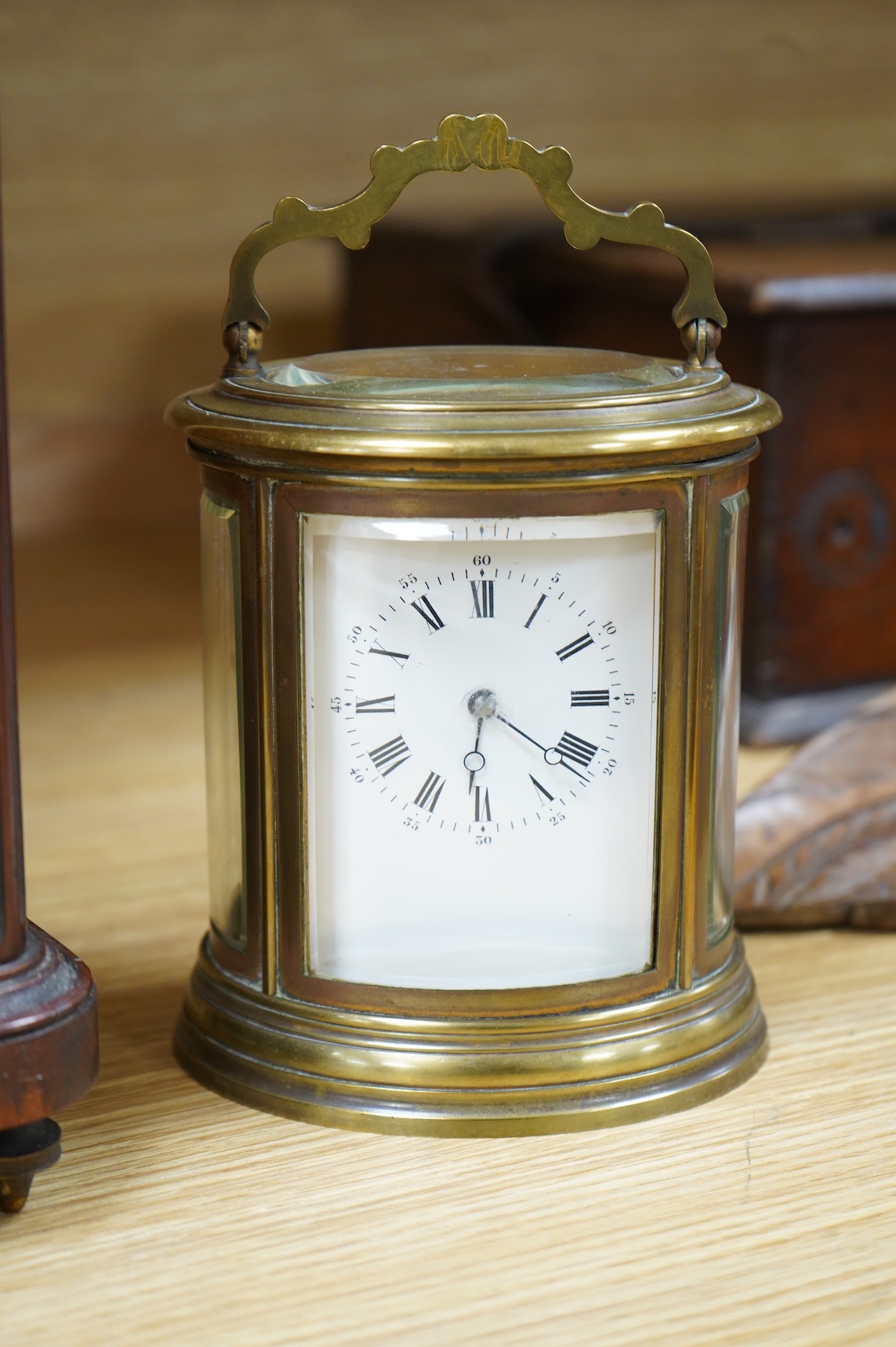A 19th century oval brass carriage clock, striking on a bell, together with a mahogany and burr yew mantel clock, striking on a coiled gong, gong missing, largest 34cm high